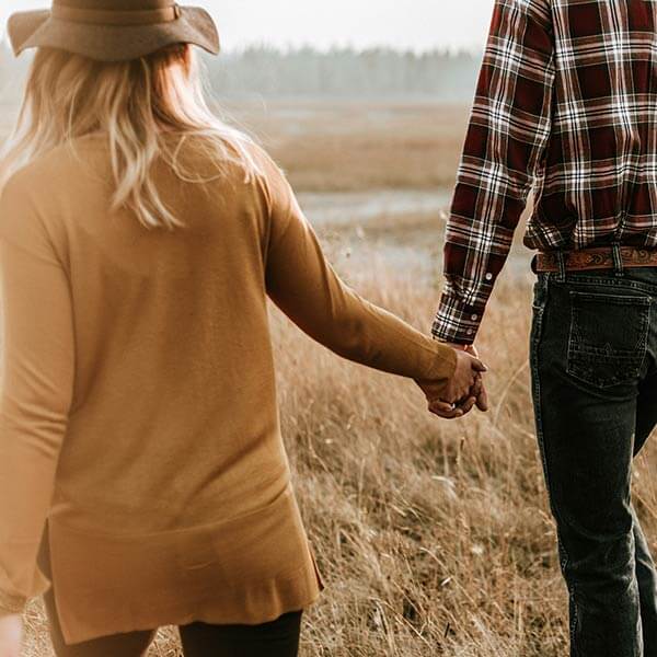 relaxed loving couple walking in a field